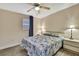 Bedroom with a ceiling fan and light colored walls and flooring, with blue tropical themed bedding at 7308 Maryland Ave, Hudson, FL 34667