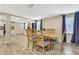 Spacious dining room adjacent to an open kitchen, featuring modern flooring at 7308 Maryland Ave, Hudson, FL 34667