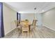 Well-lit dining room with wood floors and a neutral color scheme at 7308 Maryland Ave, Hudson, FL 34667