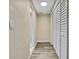 Hallway features wood floors and access to the bathroom and storage closet at 7308 Maryland Ave, Hudson, FL 34667