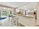 Open kitchen with bar seating and granite counters, connecting seamlessly to the living area at 7308 Maryland Ave, Hudson, FL 34667
