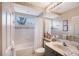 A quaint bathroom with a tub and a decorative mirror at 766 Shadow Bay Way, Osprey, FL 34229