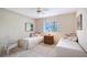 Bedroom featuring twin beds, a central nightstand, and large windows at 766 Shadow Bay Way, Osprey, FL 34229