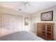 Bright bedroom featuring a ceiling fan, closet space, and complemented by a wooden cabinet at 766 Shadow Bay Way, Osprey, FL 34229