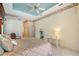 Bright bedroom with a ceiling fan and tray ceiling at 766 Shadow Bay Way, Osprey, FL 34229