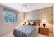 Bedroom featuring modern lamps, a map accent wall, and a window at 766 Shadow Bay Way, Osprey, FL 34229