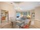 Bright dining area with a glass table, chandelier, and views into the living room, offering a spacious feel at 766 Shadow Bay Way, Osprey, FL 34229