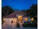 Stunning exterior view of home with landscaped front yard, brick driveway, and beautiful roofline at twilight at 766 Shadow Bay Way, Osprey, FL 34229