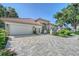 Well-maintained home exterior featuring a spacious driveway, lush landscaping, and elegant architectural details at 766 Shadow Bay Way, Osprey, FL 34229