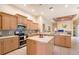 Bright kitchen featuring stainless steel appliances, ample cabinetry, and a convenient center island at 766 Shadow Bay Way, Osprey, FL 34229