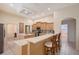 Well-lit kitchen with an extended countertop and bar stools for casual dining at 766 Shadow Bay Way, Osprey, FL 34229