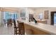 Stylish kitchen with a breakfast bar seamlessly connected to the dining area and outdoor patio at 766 Shadow Bay Way, Osprey, FL 34229