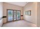 Living area featuring double doors and a view of the front yard at 766 Shadow Bay Way, Osprey, FL 34229