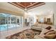 Living room featuring sliding glass doors offering views and access to the private pool and patio area at 766 Shadow Bay Way, Osprey, FL 34229