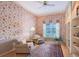 Sunlit living room featuring elegant wallpaper, plush seating, and a cozy area rug at 766 Shadow Bay Way, Osprey, FL 34229