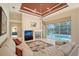 The spacious living room features a fireplace, cozy seating, and views of the pool through large windows at 766 Shadow Bay Way, Osprey, FL 34229