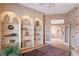 Living room with built-in shelving and a decorative rug at 766 Shadow Bay Way, Osprey, FL 34229