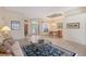 Open-concept living area showcasing tile floors, comfortable seating, and a seamless transition to the dining area at 766 Shadow Bay Way, Osprey, FL 34229
