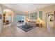 Comfortable living room featuring tile floors, neutral decor, and sliding glass doors leading to an outdoor area at 766 Shadow Bay Way, Osprey, FL 34229
