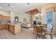Open-concept kitchen, dining and living space with tile flooring, modern finishes and abundant natural light at 766 Shadow Bay Way, Osprey, FL 34229