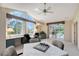 Bright office space featuring large windows overlooking the pool and outdoor living area at 766 Shadow Bay Way, Osprey, FL 34229