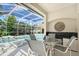Outdoor kitchen and bar area overlooking the pool, ideal for entertaining guests at 766 Shadow Bay Way, Osprey, FL 34229