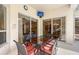 Inviting outdoor patio features a dining table and large sliding glass doors at 766 Shadow Bay Way, Osprey, FL 34229