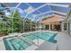 Screened pool area features a refreshing pool, relaxing spa, and outdoor seating, perfect for enjoying the Florida sunshine at 766 Shadow Bay Way, Osprey, FL 34229