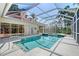 Enclosed pool area with a tiled roof, offering a private backyard oasis at 766 Shadow Bay Way, Osprey, FL 34229