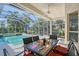 Relaxing screened-in patio with a sparkling pool, perfect for outdoor living at 766 Shadow Bay Way, Osprey, FL 34229