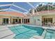 Backyard oasis with a sparkling pool, a spa, a patio, and a beautiful backyard that invites relaxation and entertainment at 766 Shadow Bay Way, Osprey, FL 34229