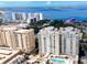 A stunning aerial view overlooking waterfront condos, a marina, and the sparkling bay at 800 N Tamiami Trl # 317, Sarasota, FL 34236