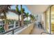 Spacious balcony with comfortable seating offering a scenic view of the fountain and lush greenery at 800 N Tamiami Trl # 317, Sarasota, FL 34236