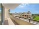 A view from a balcony overlooking Sarasota with palm trees, buildings, a lawn, and a sunny sky at 800 N Tamiami Trl # 317, Sarasota, FL 34236