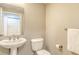 Half bath with pedestal sink, classic design, and neutral paint at 800 N Tamiami Trl # 317, Sarasota, FL 34236