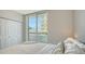 Bright bedroom featuring a large window with sliding glass doors and a view of the city at 800 N Tamiami Trl # 317, Sarasota, FL 34236
