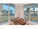Cozy dining area with a wooden table and chairs, bathed in natural light from the sliding glass doors at 800 N Tamiami Trl # 317, Sarasota, FL 34236