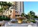 Elegant water fountain at the entrance of a condo building with lush tropical landscaping at 800 N Tamiami Trl # 317, Sarasota, FL 34236