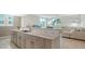 Stylish kitchen featuring granite counters, white tile backsplash, and an open layout connecting to the living room at 800 N Tamiami Trl # 317, Sarasota, FL 34236