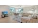 Bright living room with light wood floors, modern furniture, and large windows showcasing scenic views at 800 N Tamiami Trl # 317, Sarasota, FL 34236