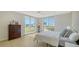 Bright bedroom featuring hardwood floors, light walls, and large windows offering city views and balcony access at 800 N Tamiami Trl # 317, Sarasota, FL 34236