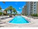 Outdoor pool is surrounded by lounge chairs and palm trees at 800 N Tamiami Trl # 317, Sarasota, FL 34236