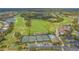 Aerial view of the community featuring a golf course, tennis court, swimming pool and lake at 8735 Olde Hickory Ave # 8205, Sarasota, FL 34238