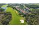 Aerial view of condo building complex on a golf course with lakes and mature trees at 8735 Olde Hickory Ave # 8205, Sarasota, FL 34238