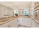 Bathroom featuring dual sinks, neutral countertops, and large mirror with ample lighting at 8735 Olde Hickory Ave # 8205, Sarasota, FL 34238