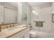 Bright bathroom featuring a tub shower with glass doors and an elegant vanity at 8735 Olde Hickory Ave # 8205, Sarasota, FL 34238