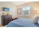 Comfortable bedroom featuring a dresser, mounted TV, and window shutters at 8735 Olde Hickory Ave # 8205, Sarasota, FL 34238