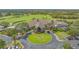 Aerial view of the clubhouse, a golf course, and parking at 8735 Olde Hickory Ave # 8205, Sarasota, FL 34238