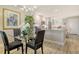 Dining area with glass table and chairs, next to a kitchen with white cabinets and granite countertops at 8735 Olde Hickory Ave # 8205, Sarasota, FL 34238