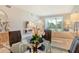 Stylish dining area with a glass table and views of the beautifully manicured backyard at 8735 Olde Hickory Ave # 8205, Sarasota, FL 34238